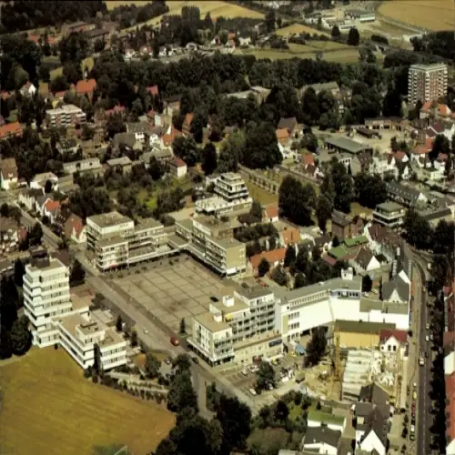 Ak Ahrensburg in Holstein, Luftaufnahme, Wohngebäude, Geschäfte, Parkplätze, ländliche Umgebung