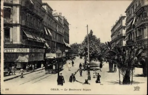 Ak Oran Algerien, Boulevard Seguin, Straßenbahn, Geschäfte, Petit Paris, Palmen