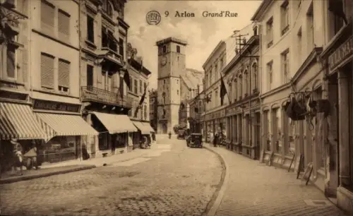 Ak Arlon Aarlen Wallonien Luxemburg, Straße mit Uhrturm, Geschäfte, Autos,  Atmosphäre