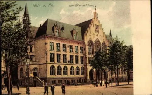 Ak Köln am Rhein, Handelshochschule, Gebäude mit Türmen, Bäume, Straßenansicht