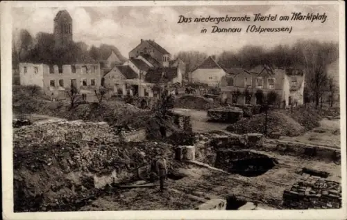 Ak Domnowo Domnau Ostpreußen, Das niedergebrannte Viertel am Marktplatz