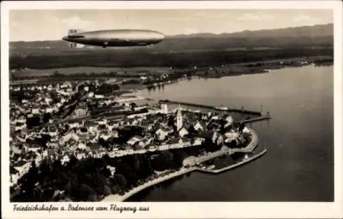 Ak Friedrichshafen am Bodensee, Luftaufnahme von Friedrichshafen, Bodensee, Zeppelin im Himmel