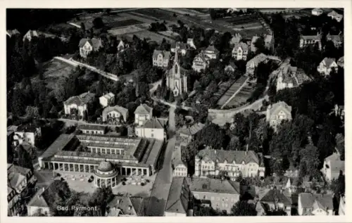 Ak Bad Pyrmont in Niedersachsen, Luftaufnahme von  Gebäude, Bäume, Straßen