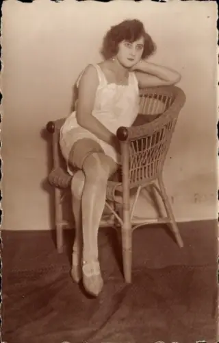 Foto Ak Frau im Unterkleid auf einem Korbsessel, Strümpfe