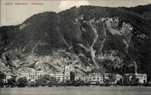 Ak Interlaken Kanton Bern Schweiz,  Höheweg, Berge im Hintergrund,  Gebäude