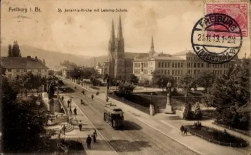 Ak Freiburg im Breisgau,  St. Johannis-Kirche, Lessing-Schule, Straßenansicht, Straßenbahn