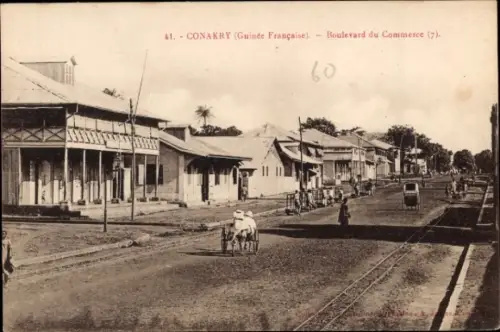 Ak Conakry Guinea,  Boulevard du Commerce, Straßenansicht, Pferdekutsche, Häuser