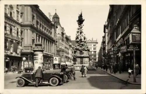 Ak Wien 1 Innere Stadt, Straße mit monumentaler Statue, alte Autos, Geschäfte, Werbung