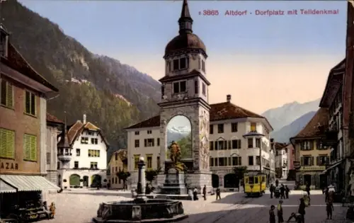 Ak Altdorf Kt Uri, Dorfplatz mit Telldenkmal,  Brunnen, Gebäude, Straßenbahn