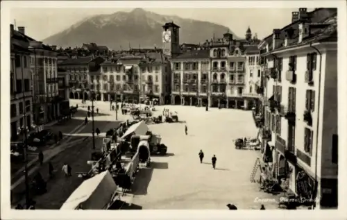 Ak Locarno Kanton Tessin Schweiz,  Piazza Grande, Berg im Hintergrund, Menschen, Marktstände