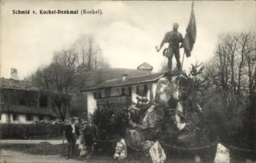 Ak Kochel am See Oberbayern, Schmid v. Kochel-Denkmal, Statue mit Fahne, Bäume, Felsen