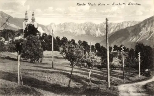 Ak Maria Rain in Kärnten, Kirche mit zwei Türmen, Bergkette, Bäume und Wiese, Telegraphenmasten, 