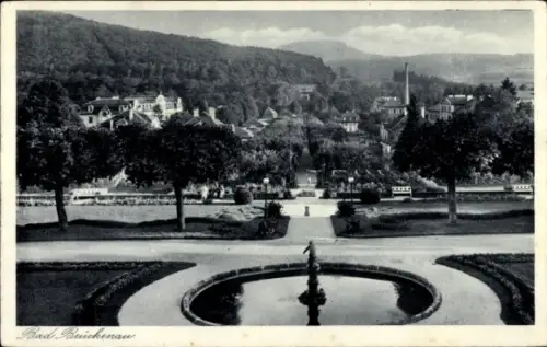 Ak Bad Brückenau im Sinntal Unterfranken, Springbrunnen, symmetrische Wege, Baumreihen, Parkufer 