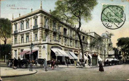 Ak Cairo Kairo Ägypten, Geschäftshaus mit Markisen, Passanten und Pferdekutschen, Straßenlaterne,