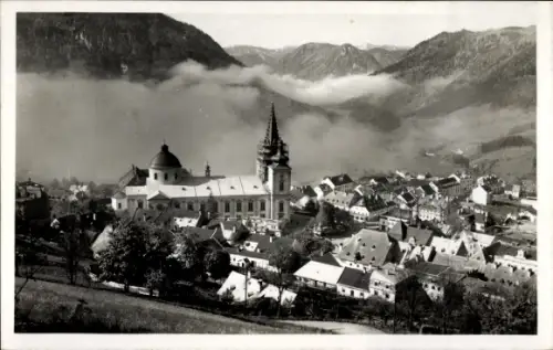 Ak Mariazell Steiermark, Kirche mit hohem Turm und Kuppel, zahlreiche Häuser, Nebel im Tal, umlie