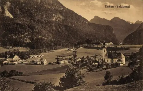 Ak Unken in Salzburg, Kirche mit Turm, Dorfhäuser, Wiesen und Felder, Bergkette, See im Tal