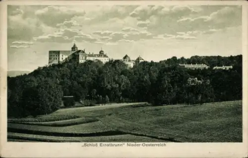 Ak Ernstbrunn in Niederösterreich, großes Gebäude auf Hügel, dichte Bäume, geordnete Felder, Weg 