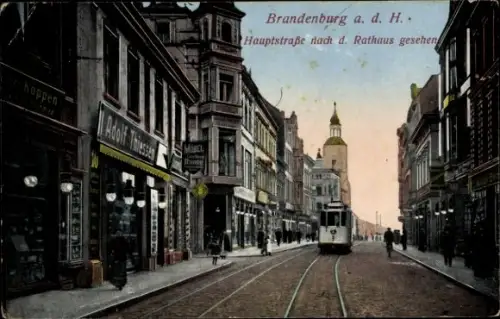 Ak Brandenburg an der Havel, Hauptstraße mit Straßenbahn und Schienen, Ladenfronten mit Schildern