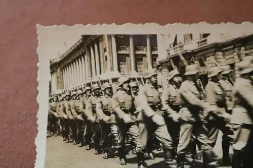 altes Foto Soldaten marschieren durch Stadt - Ort ??rückseitig beschrieben 1940