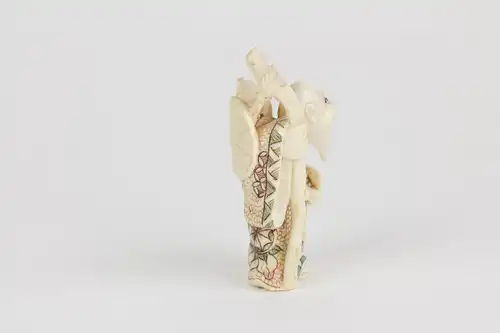 Netsuke, Japan, Anf. 20. Jh., Bein, Chokwaro mit Wanderstab und Kürbisflasche auf Schulter, farbig abgesetzt, signiert, Gebrauchsspuren, H: 6 cm.