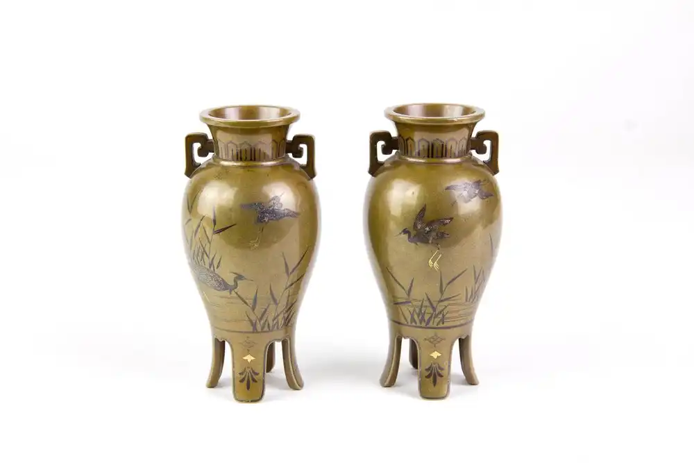 Paar Vasen, Japan, Meiji-Zeit, um 1900, Bronze, umlaufend mit feinen Gold- und Silbereinlagen verziert, zwei Kraniche im Schilf, und ein Kranich im Anflug, Gebrauchsspuren, H: 10,5 cm. 0