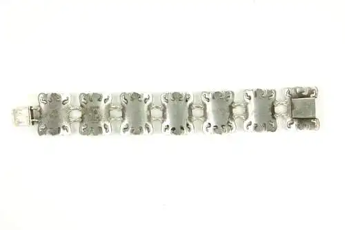 Armband, Mexiko, 20. Jh., 925er-Silber, und 10 Karat Gold, massives, gegliedertes Silberarmband, Glieder mit geprägten, und mit verschiedenen Motiven verzierten Goldblechen, Gebrauchsspuren, L: ca. 20 cm, 50 g.