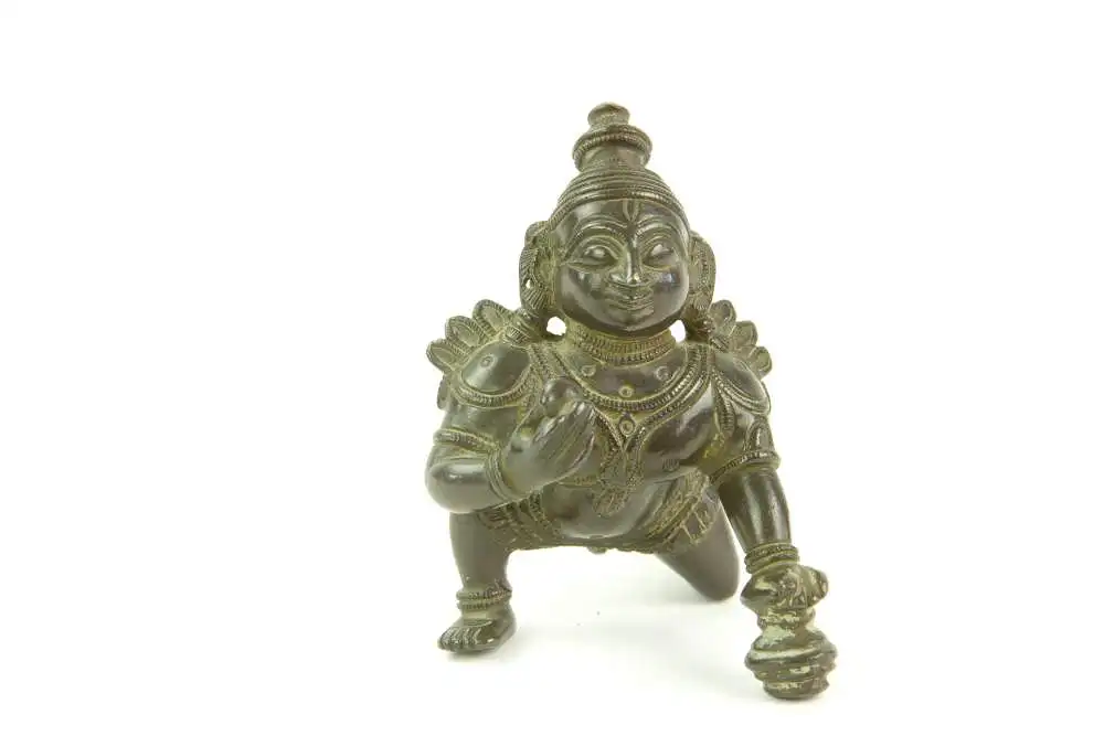 Krishna - Figur, Indien, 19./20. Jh., Bronze, Krishna kniend und Hand auf Butterkugel, Gebrauchsspuren. H: 8 cm. 0