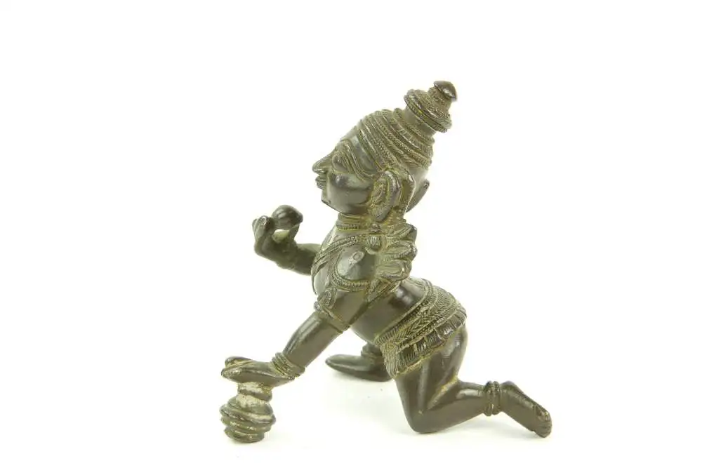 Krishna - Figur, Indien, 19./20. Jh., Bronze, Krishna kniend und Hand auf Butterkugel, Gebrauchsspuren. H: 8 cm. 1