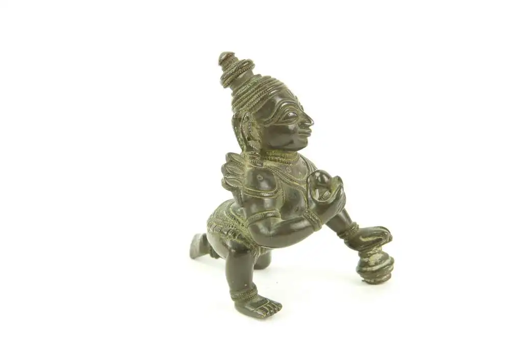 Krishna - Figur, Indien, 19./20. Jh., Bronze, Krishna kniend und Hand auf Butterkugel, Gebrauchsspuren. H: 8 cm. 3