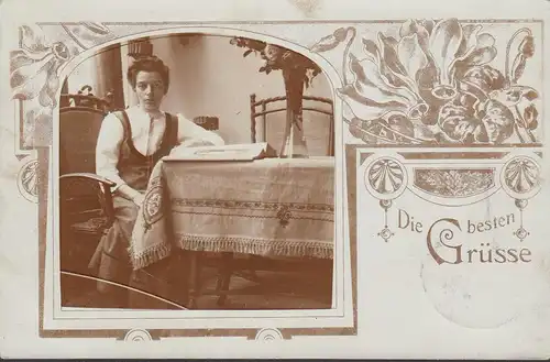Die beste Grüsse, Frau am Tisch, Foto- AK, gelaufen 1912