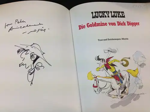 Morris: Lucky Luke. Die Goldmine von Dick Digger. Text und Zeichnungen: Morris. Mit eigenhändiger Widmung und Tuschzeichnung auf dem Vorsatzblatt. 