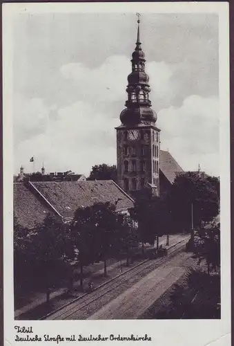 [Echtfotokarte schwarz/weiß] Tilsit Deutsche Straße mit Deutscher Ordenskirche, sehr seltener Stempel "TAUROGGEN" (litauisch: Tauragė). 