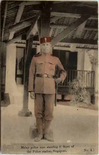 Singapore - Malay police man standing in front of police station -643272