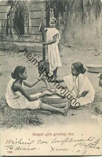 India - Bengali girls grinding rice