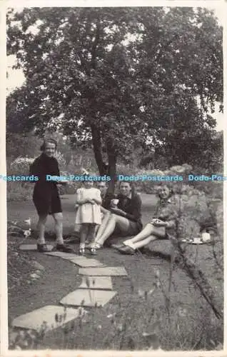 R190135 Damen. Mann. Mädchen. im Garten sitzen. Alte Fotografie. Postkarte