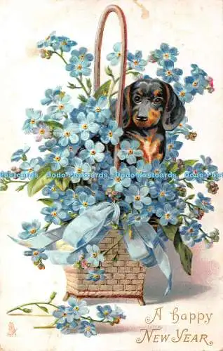 R367938 Ein Happy New Year Hund sitzt im Korb mit blauen Blumen Stecken Neujahr S