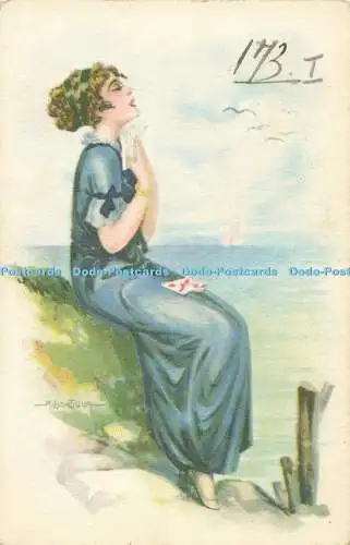 R557737 Frau im blauen Kleid sitzt am Meer E C N V