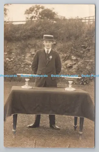 R804337 Junge im Anzug stehend am Tisch