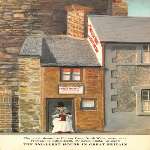 A718 Wales kleinstes Haus Großbritanniens ethnische Frau Vintage Postkarte