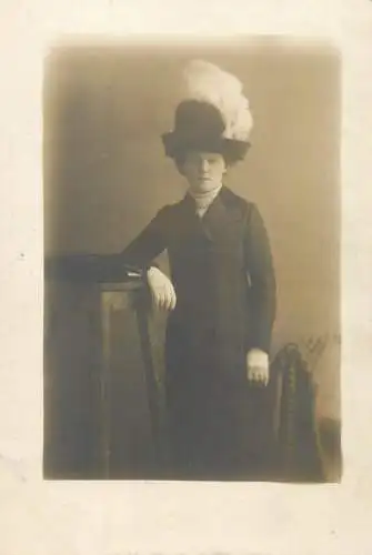 Fashion woman posing with fancy feather hat
