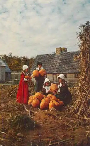 USA Plymouth MA Children in Pilgrim costumes portray the Thanksgiving harvest from Plimoth Plantation