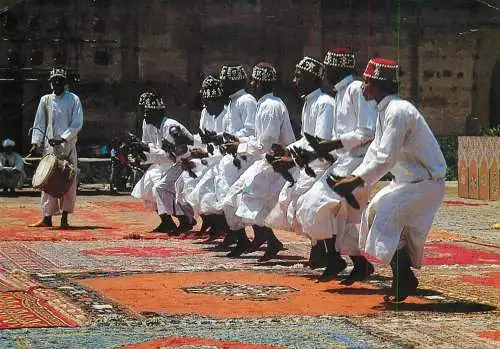 Morocco Gnaouas men ethnic types doing an traditional dance in typical clothing