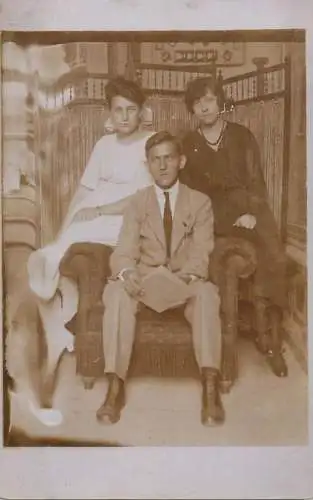 Photographic postcard anonymous persons souvenir young man and two ladies