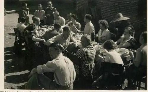 Photographic image anonymous persons at a table