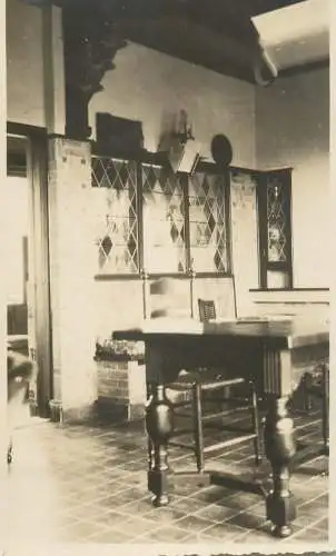 Photographic postcard interior to identify