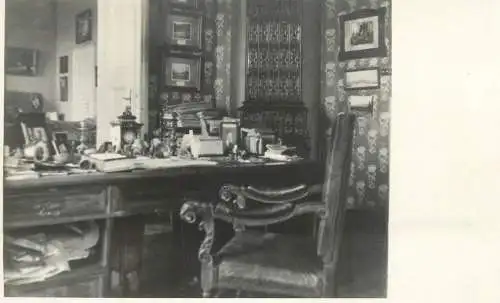 Photographic postcard interior to identify