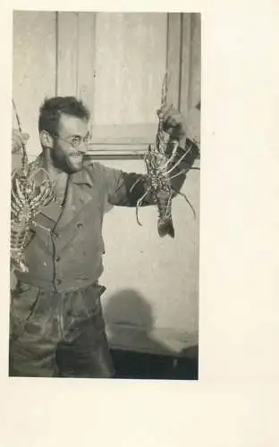 Social history annonymous persons souvenir photo man with seafood crabs