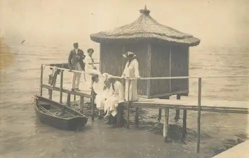 Photograph family in water bungalow and rowboat
