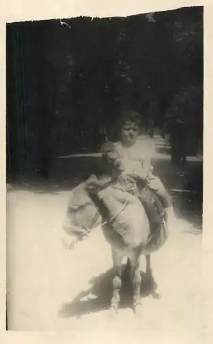 Real photo child on a donkey