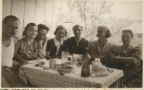 Social history anonymous persons portrait souvenir family in the yard